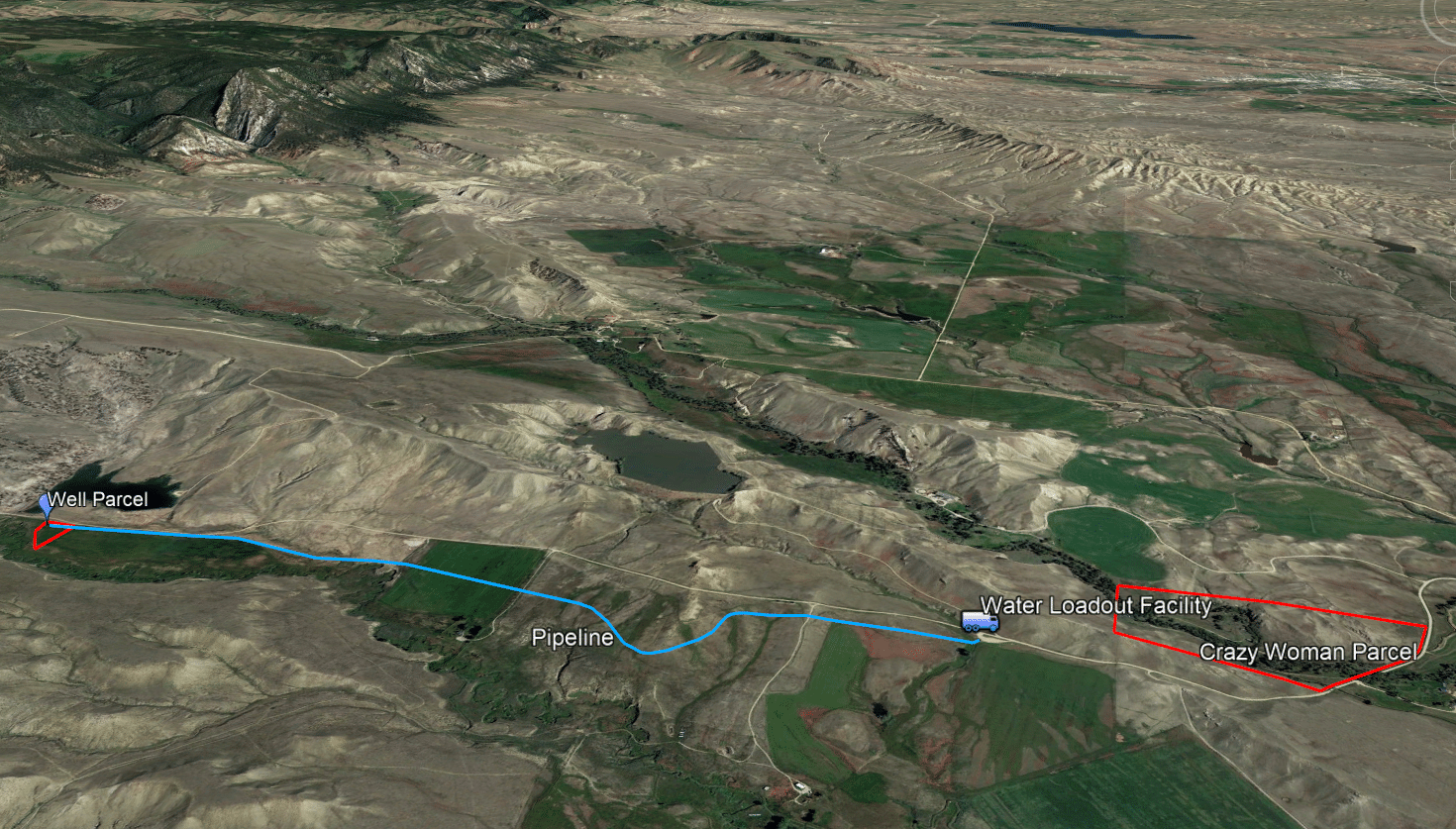 Aerial map displays a pipeline route from a Well Parcel to a Water Loadout Facility and on to the Crazy Woman Parcel, with labeled paths across rural terrain—ideal for those seeking land for sale or unique recreational land opportunities.
